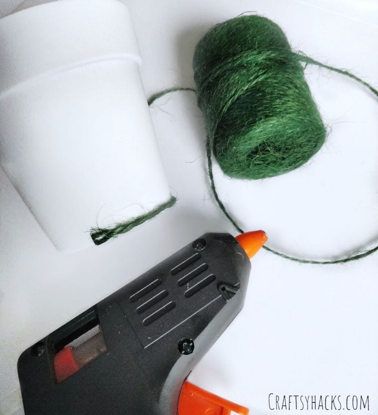green twine with flower pot and hot glue