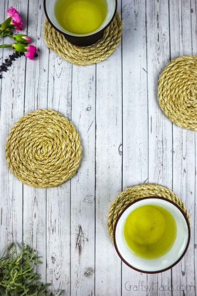 cups on rope coasters with flowers