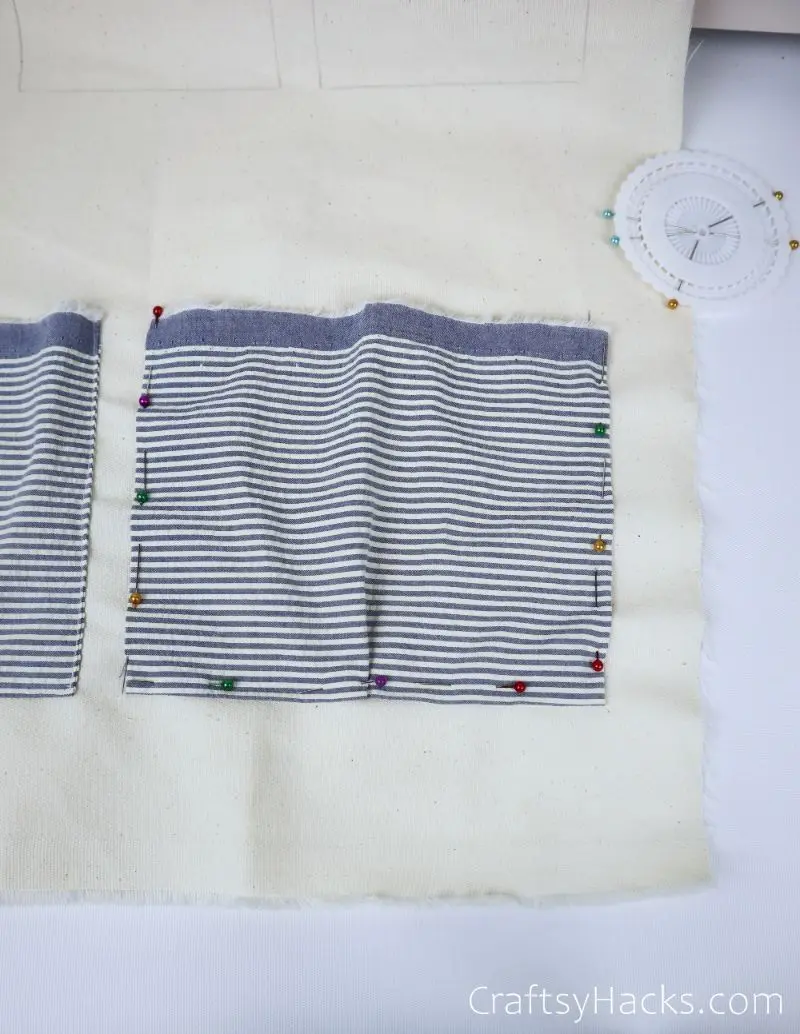 fabric rectangle with pins all around