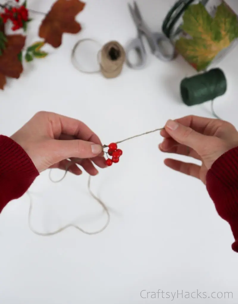 wrapping red berries in twine