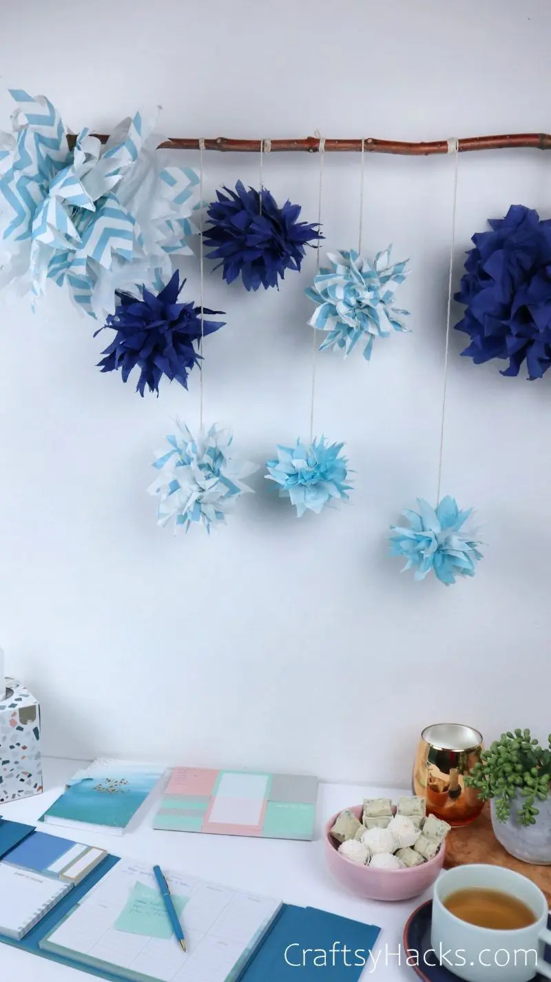 pom poms hanging from stick