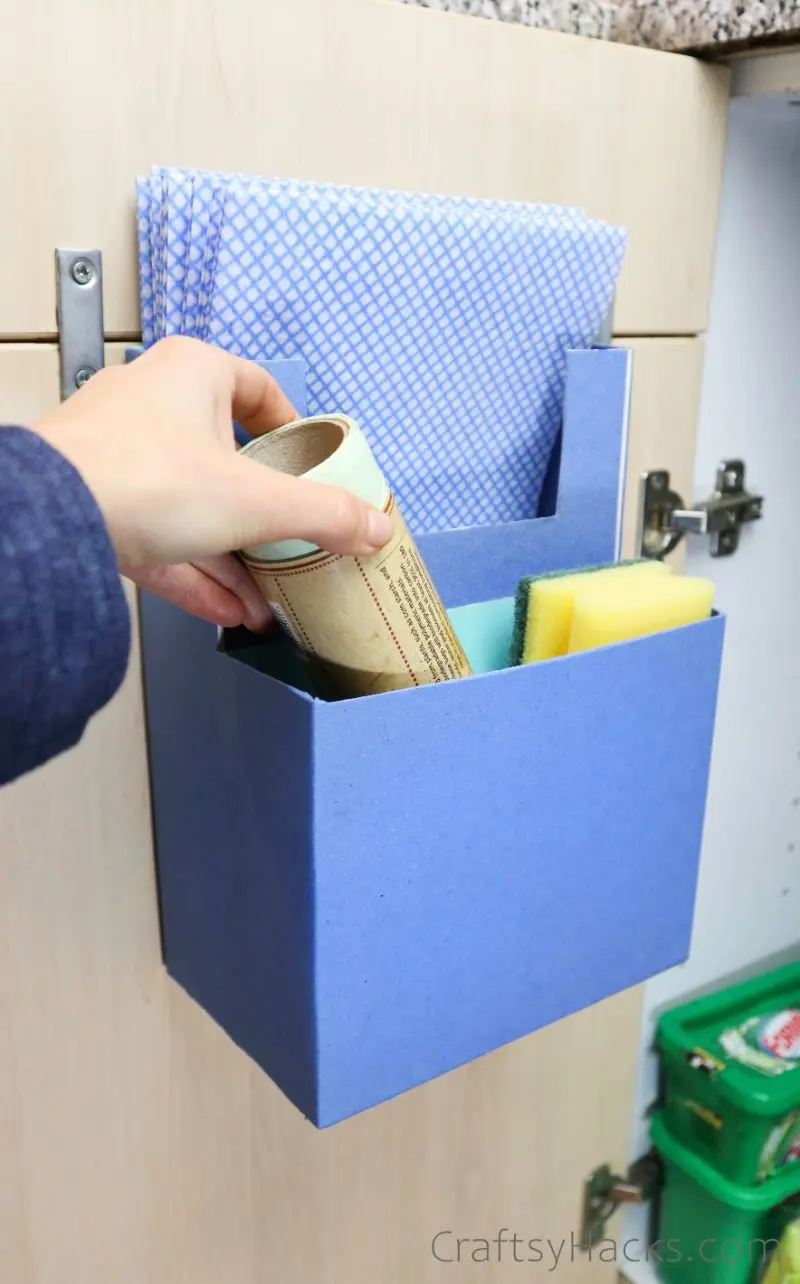 adding cleaning products to organizer