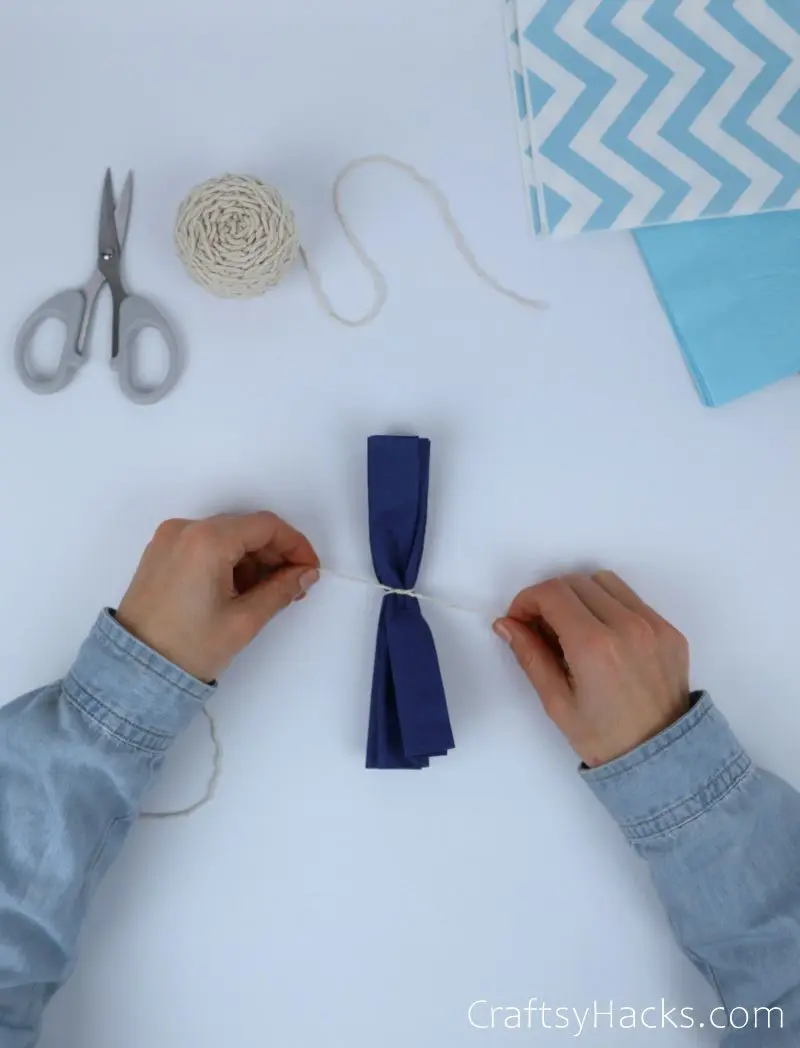 tying string around tissue paper