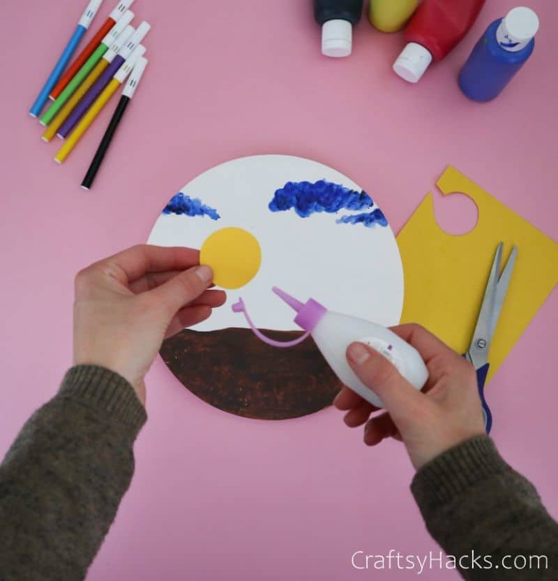 glueing sun on paper plate