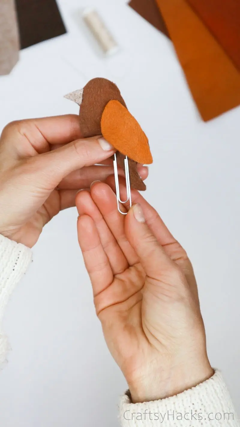 putting paper clip on bookmark