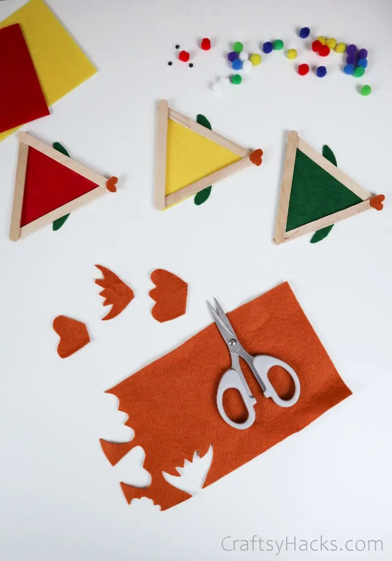 cutting tail shapes from orange felt
