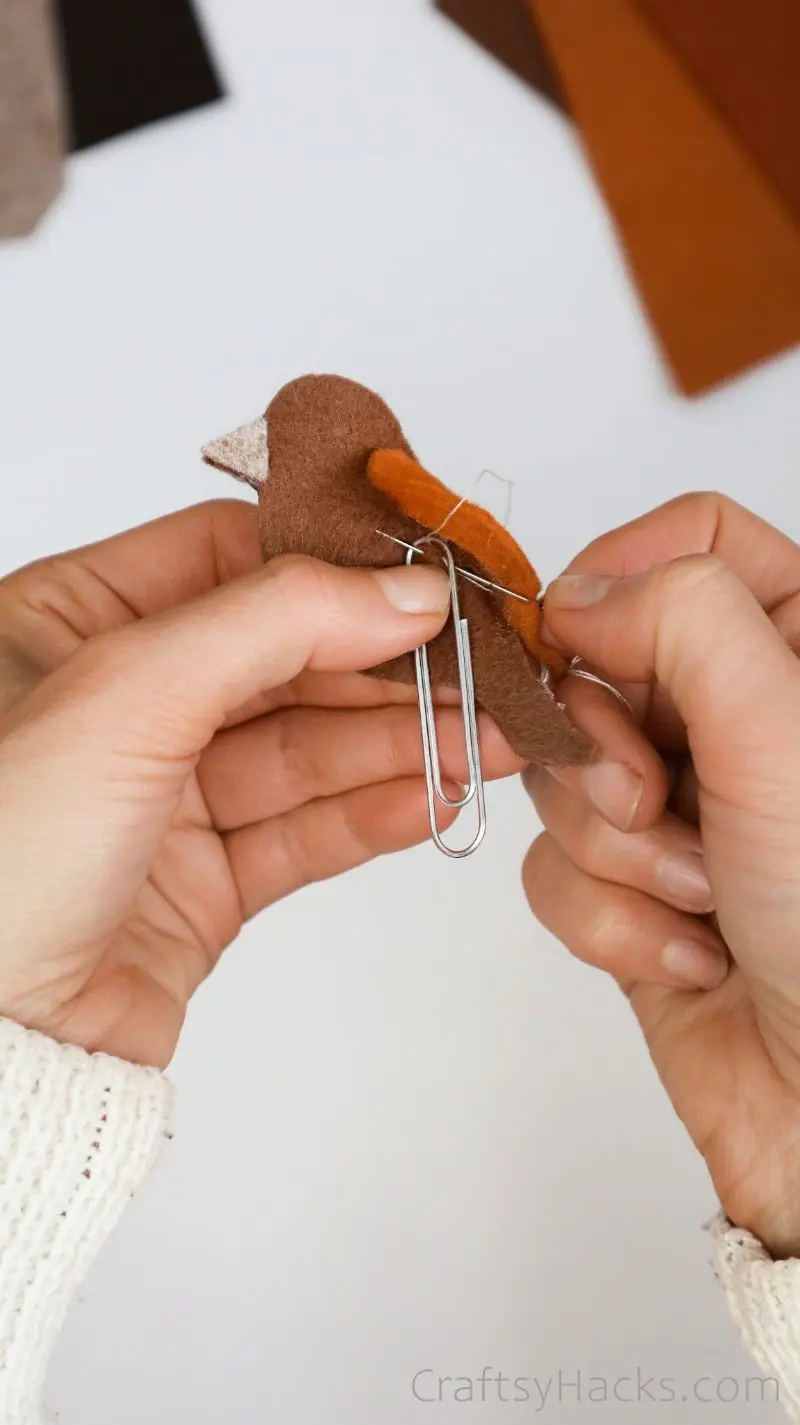 sewing paperclip onto bookmark