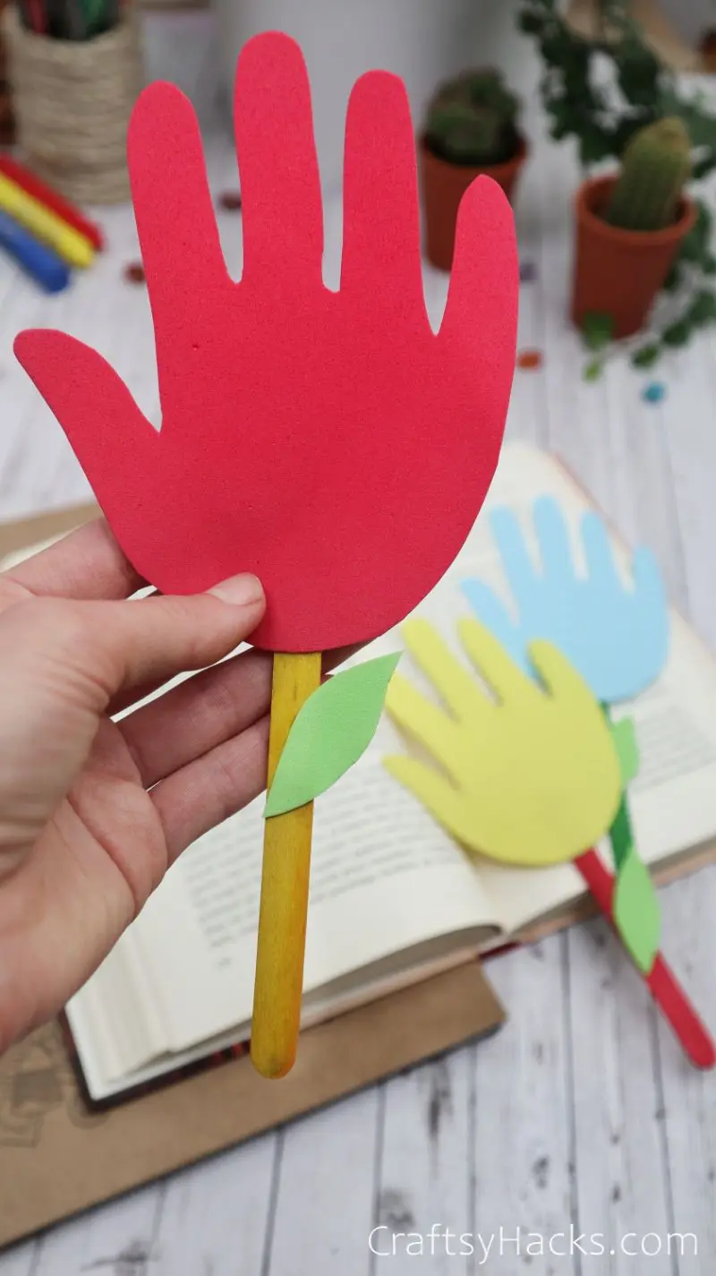 holding red handprint bookmark