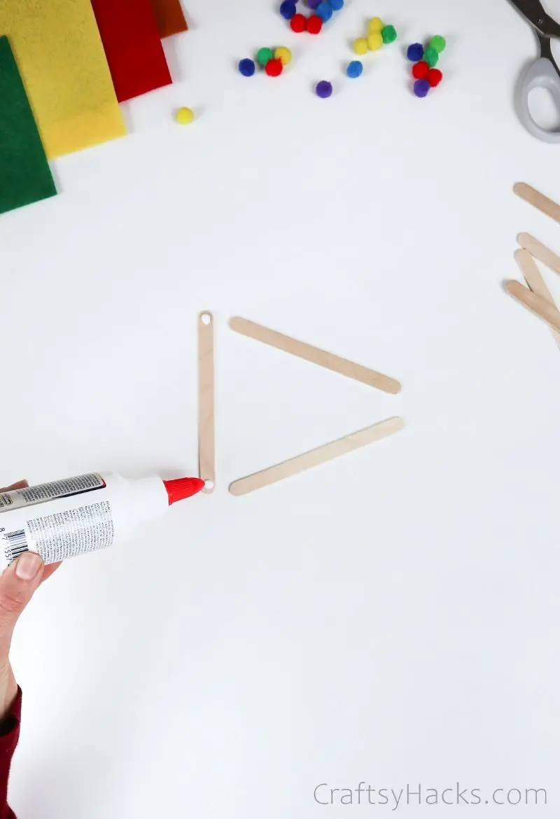 putting glue on popsicle sticks