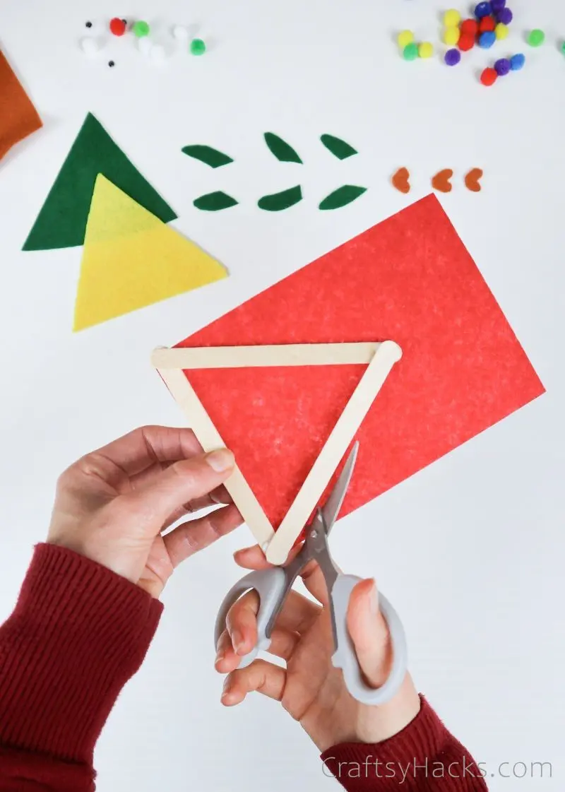 cutting felt around popsicle stick triangle