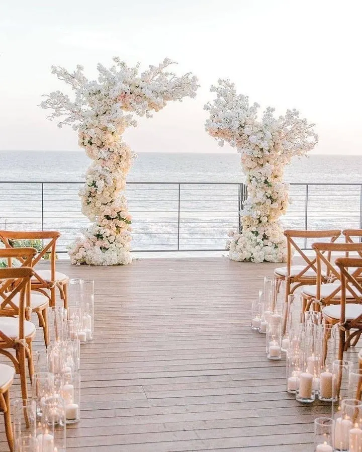 candles and white floral arches