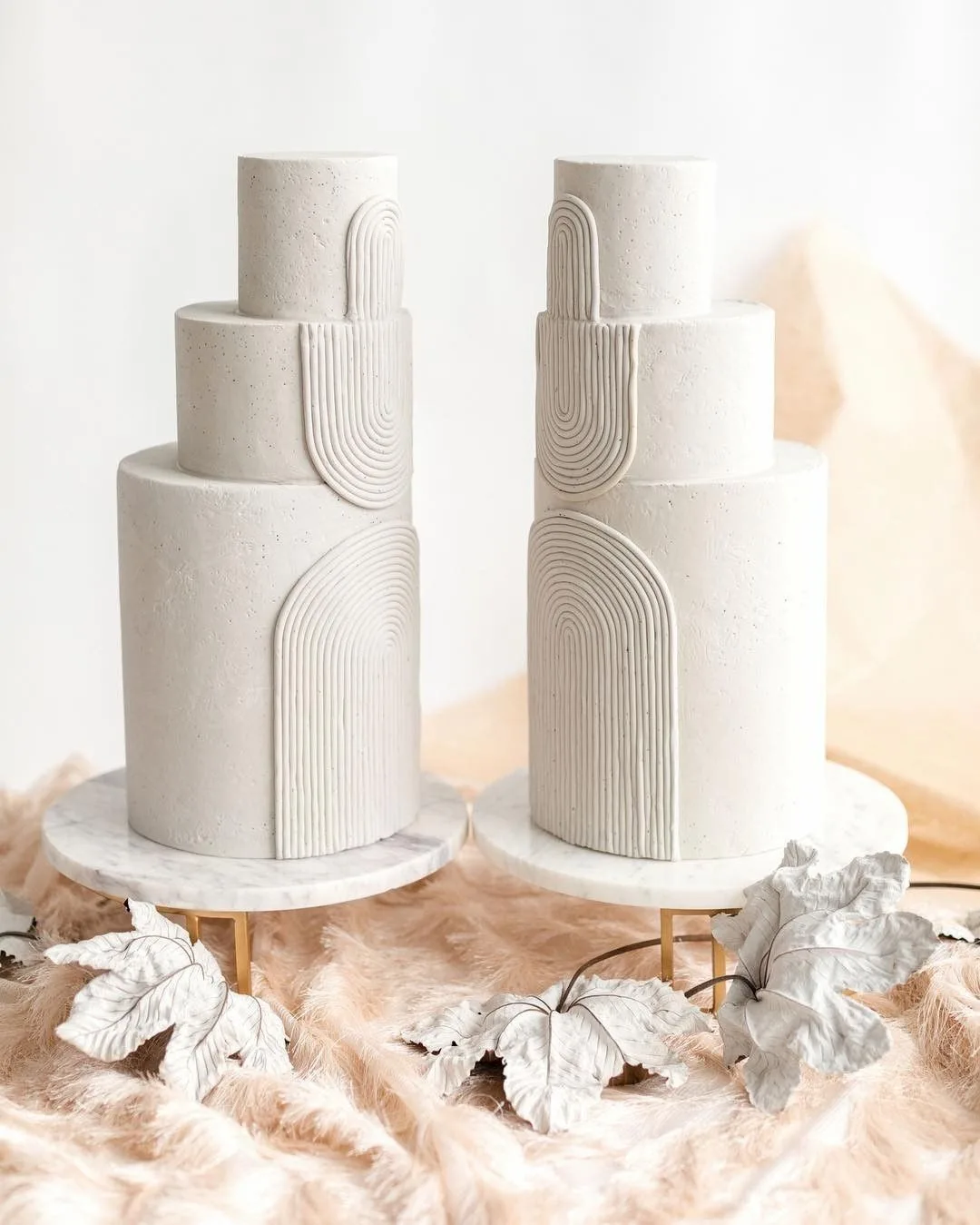 two cakes with white arches