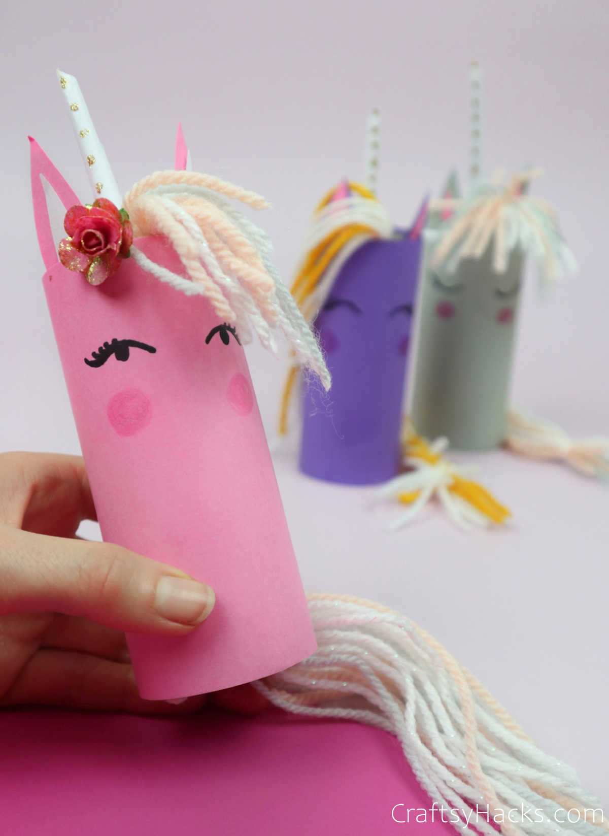 holding pink paper roll unicorn