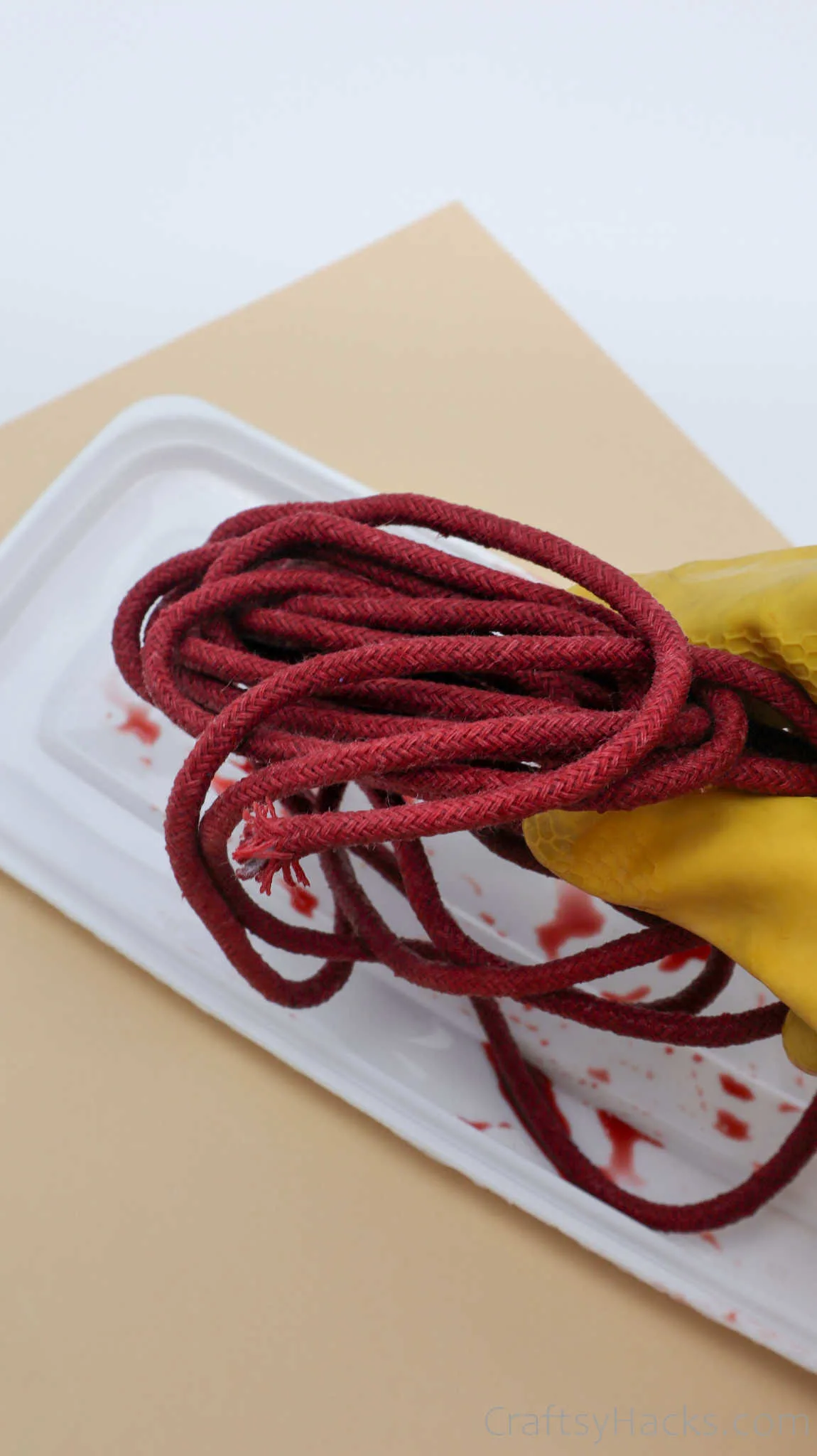 holding red dyed rope
