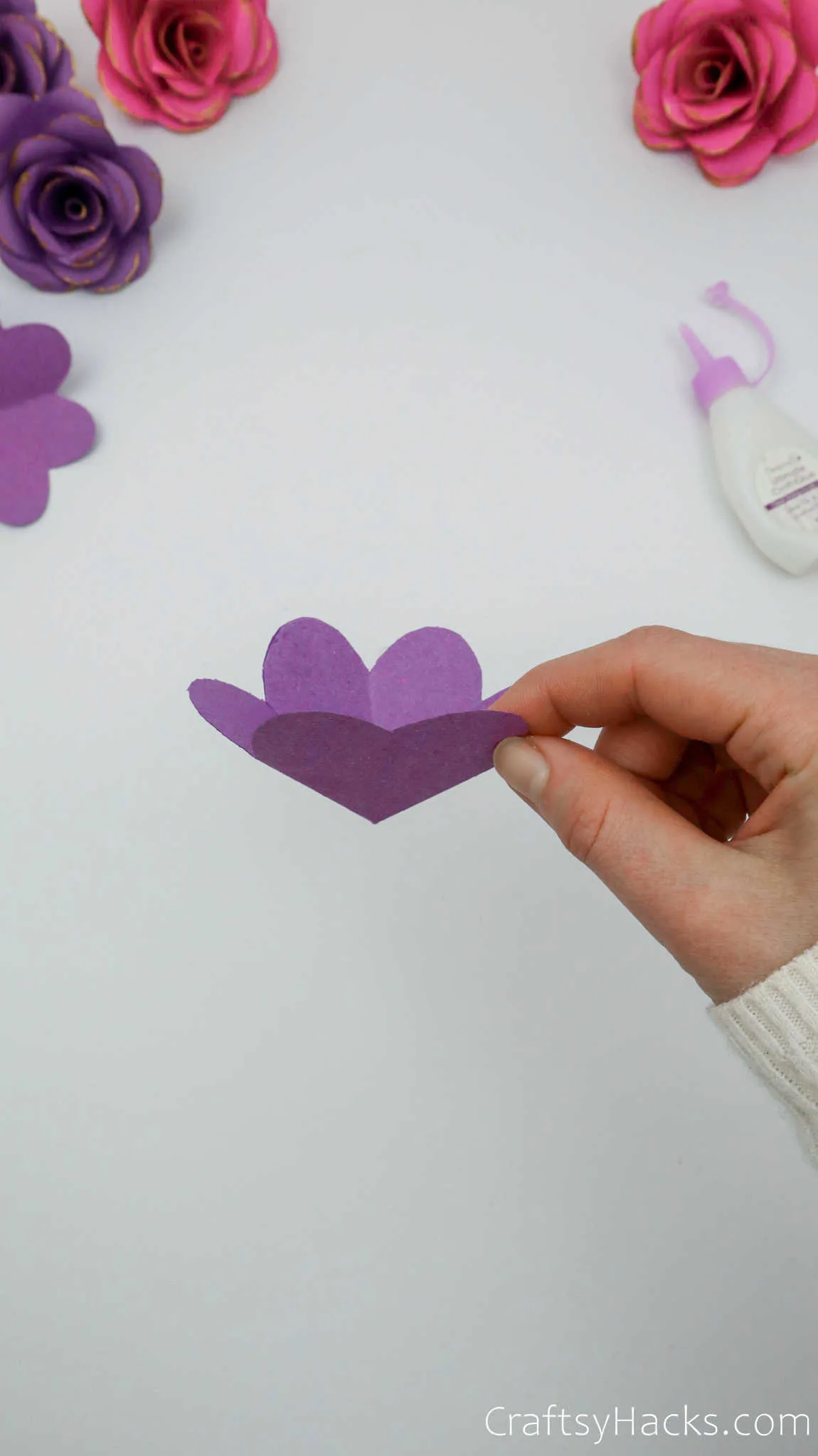 holding paper flower