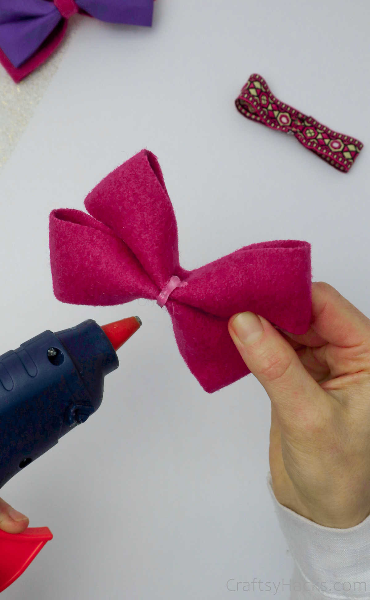 adding glue to pink bow