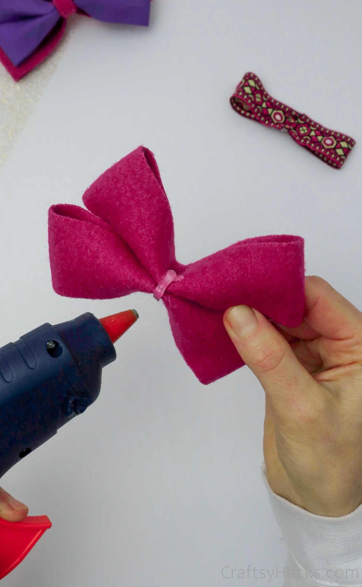 adding glue to pink bow