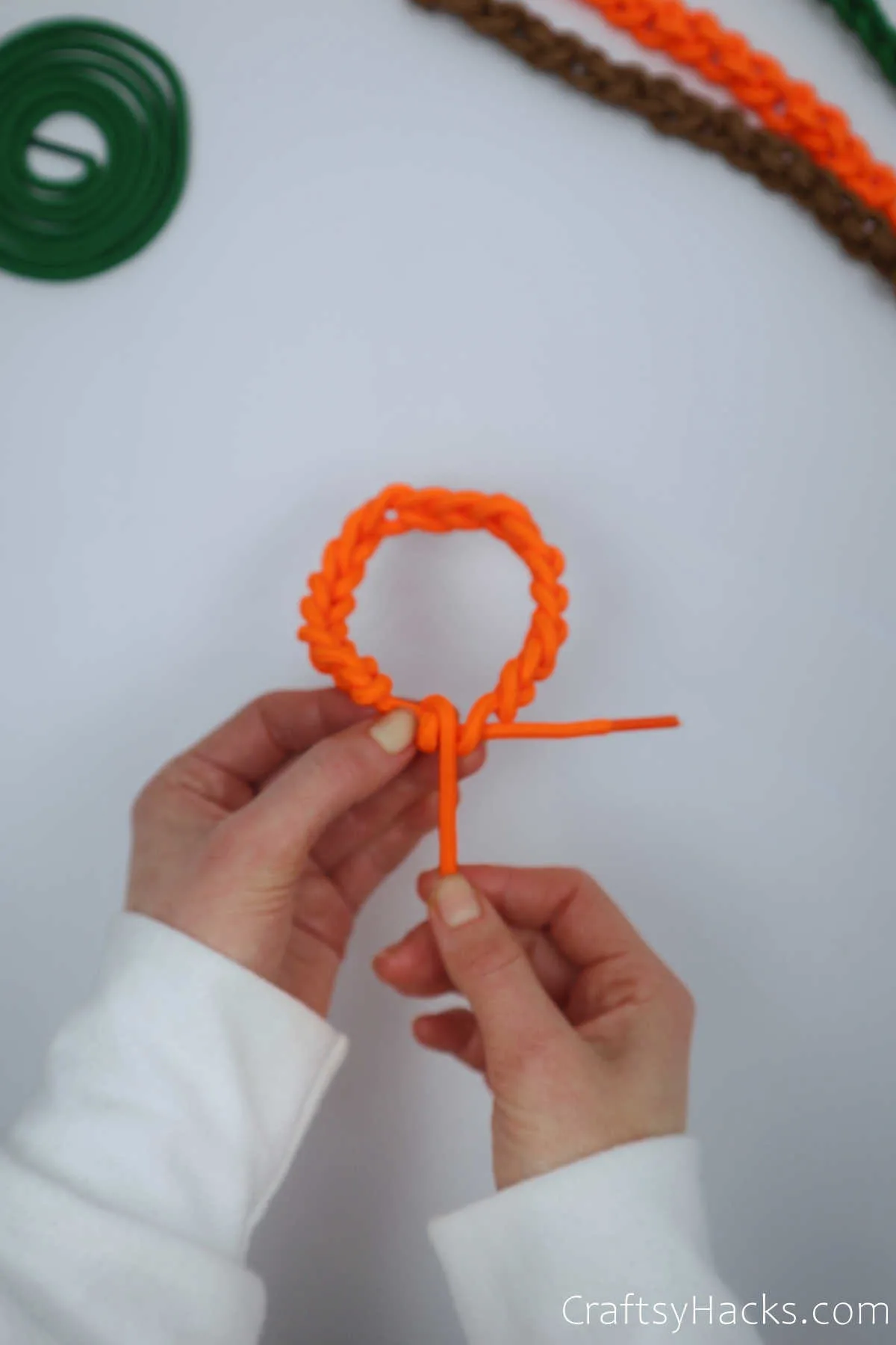 holding orange bracelet