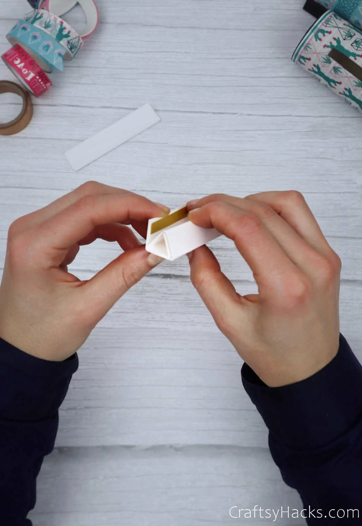 holding paper triangle