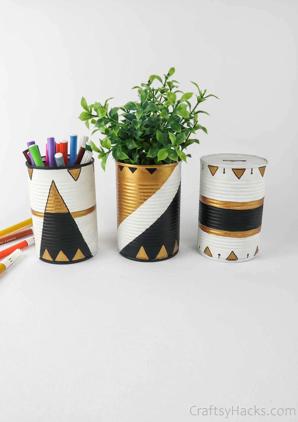 tin cans with pens, and plant