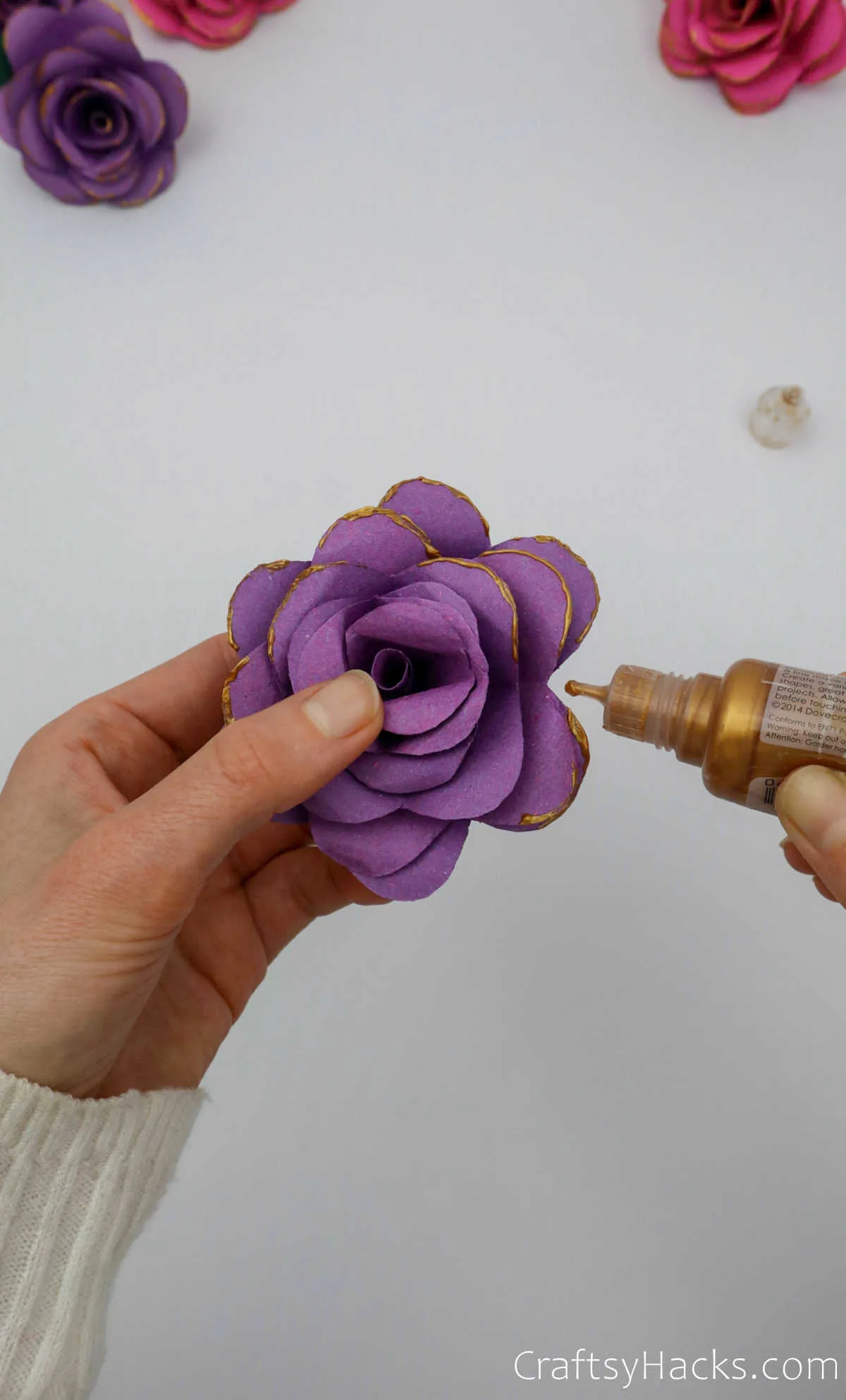 adding gold paint to flower