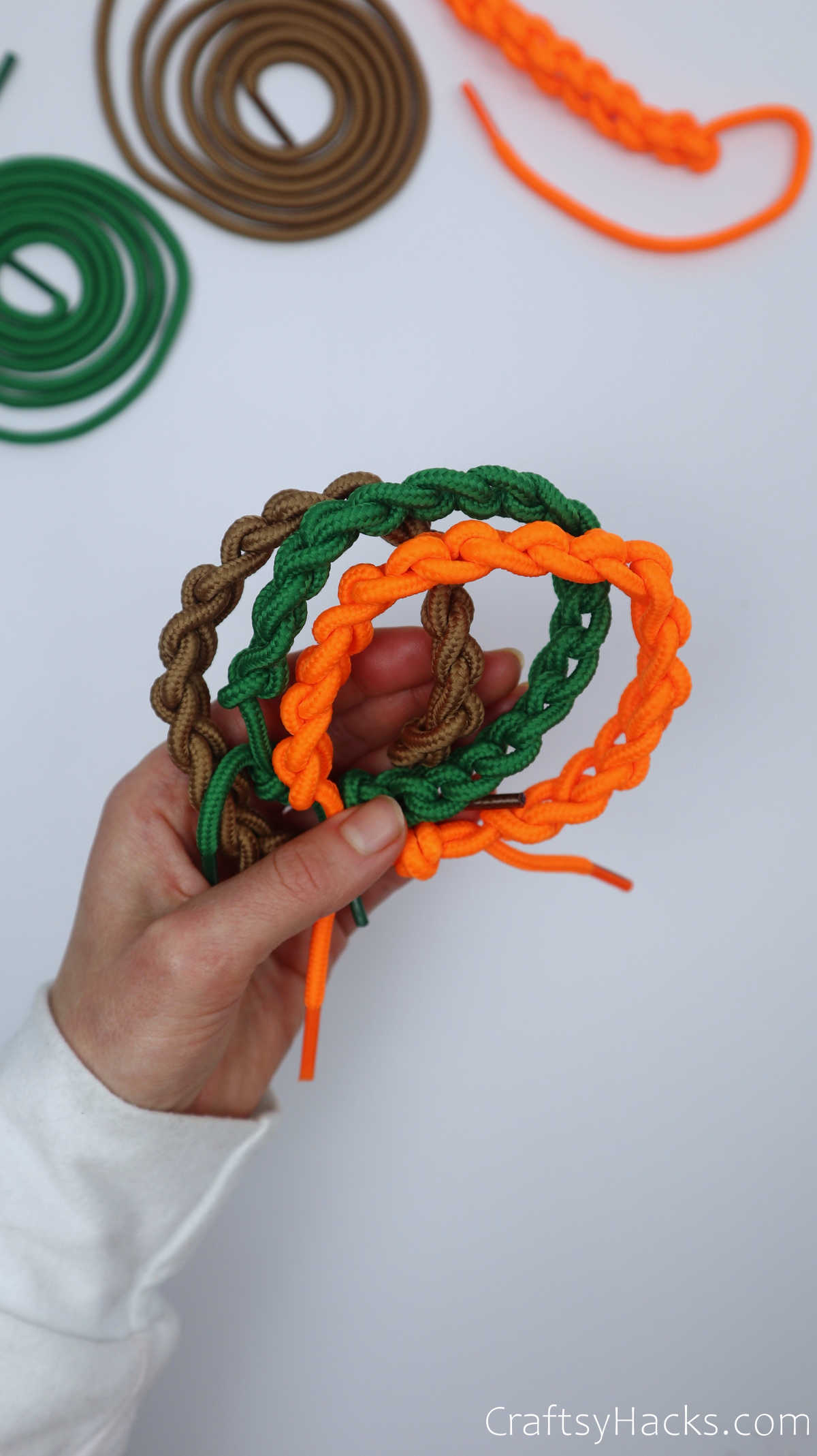 brown, green and orange shoelace bracelets
