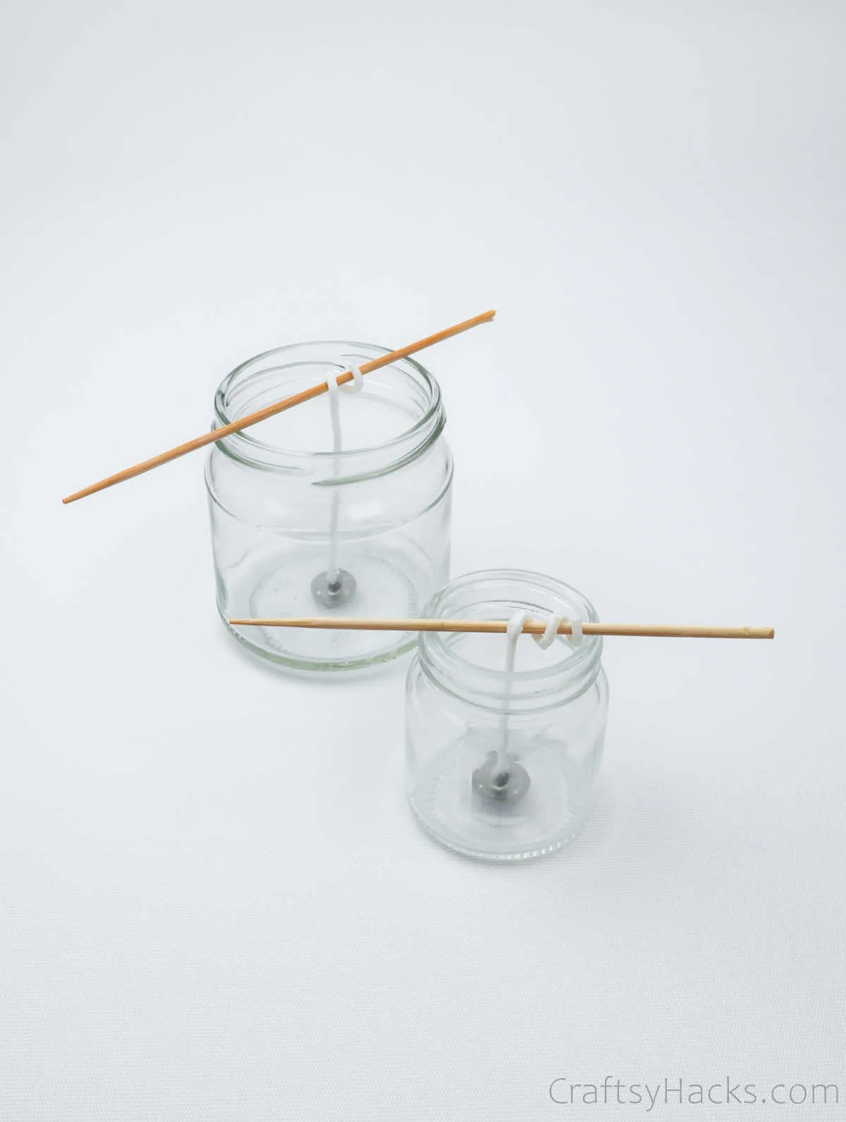 two jars with wicks