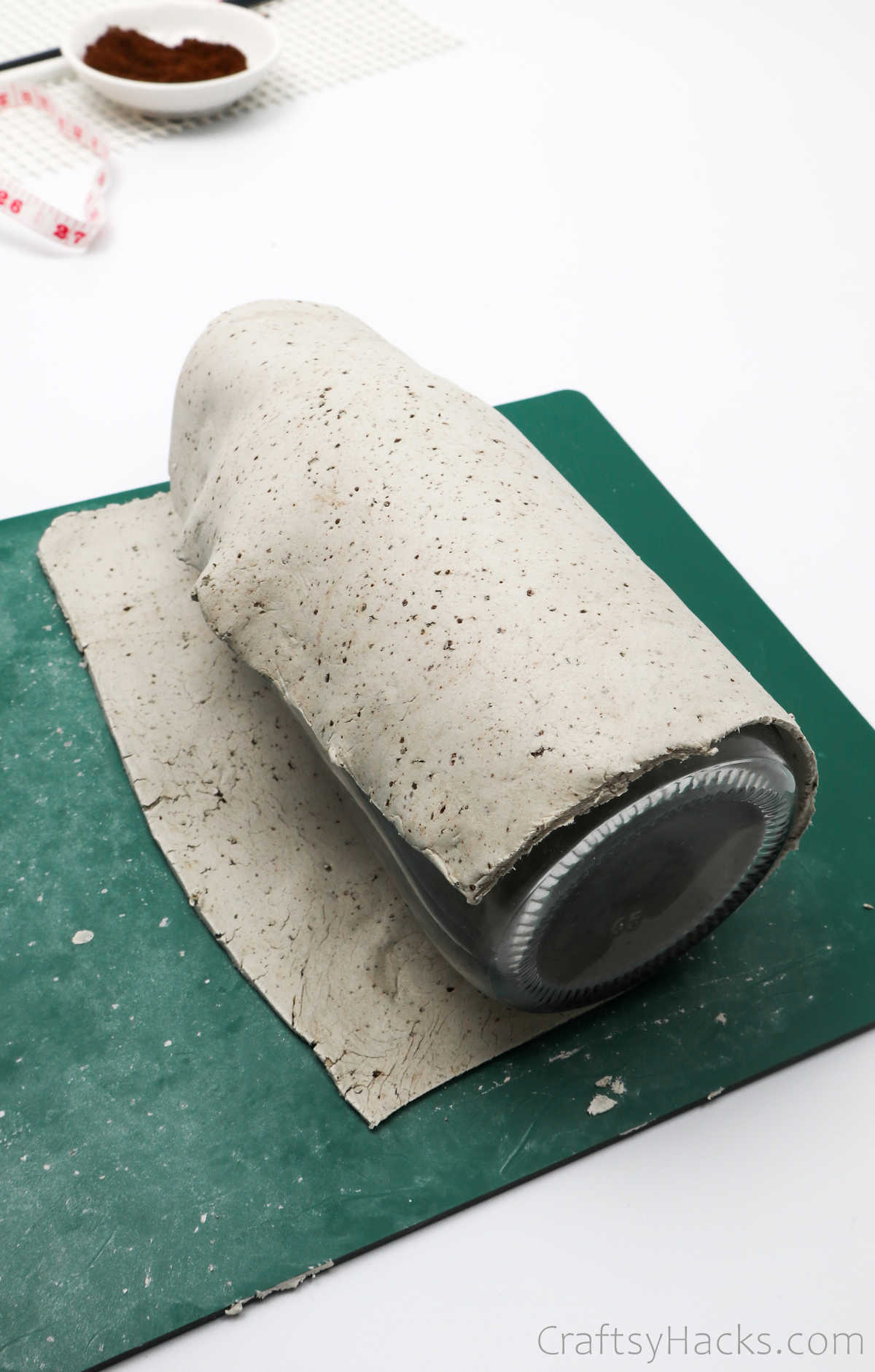 covering bottle with clay