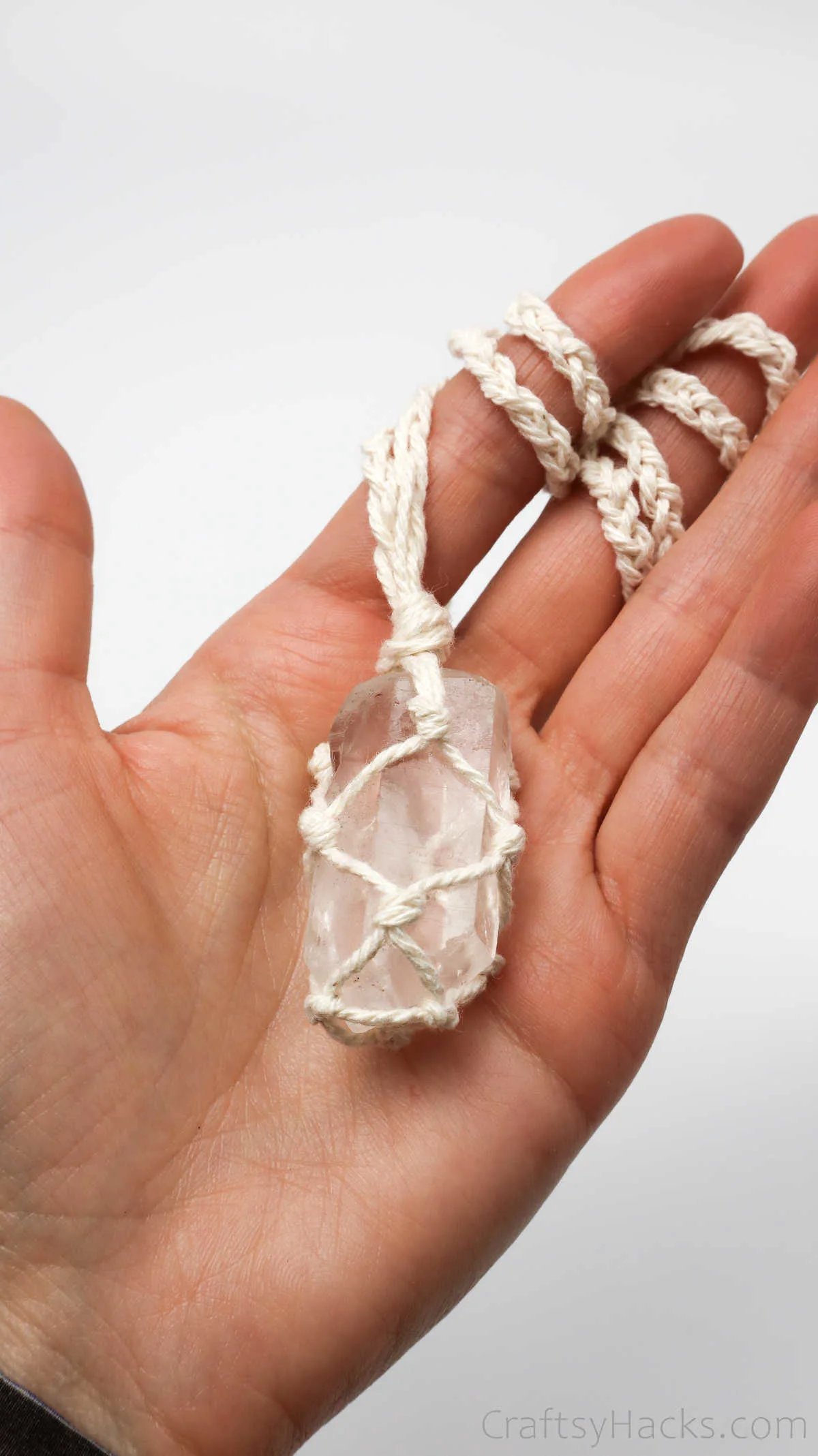 holding macrame necklace