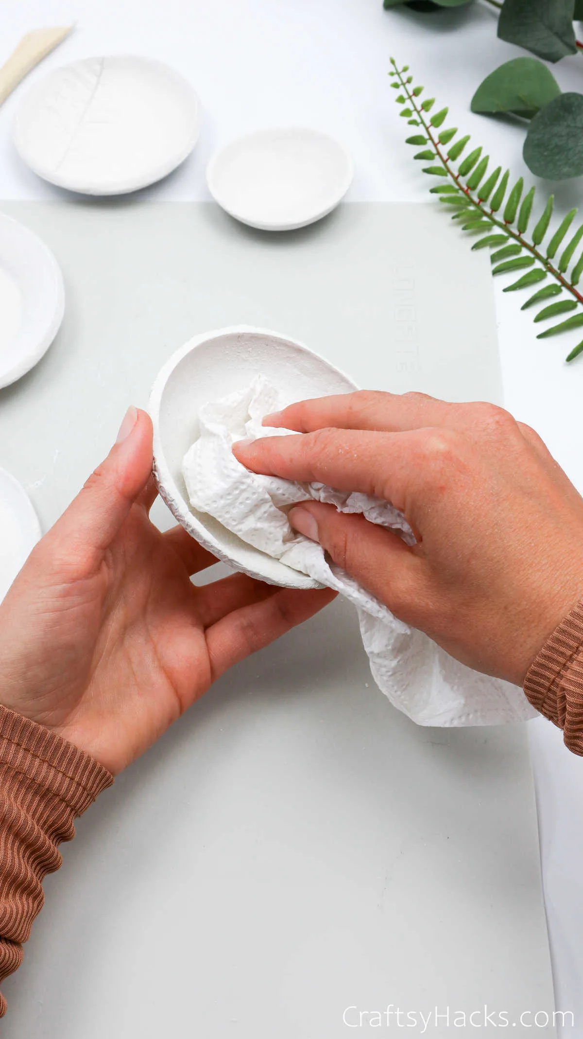 wiping clay bowl