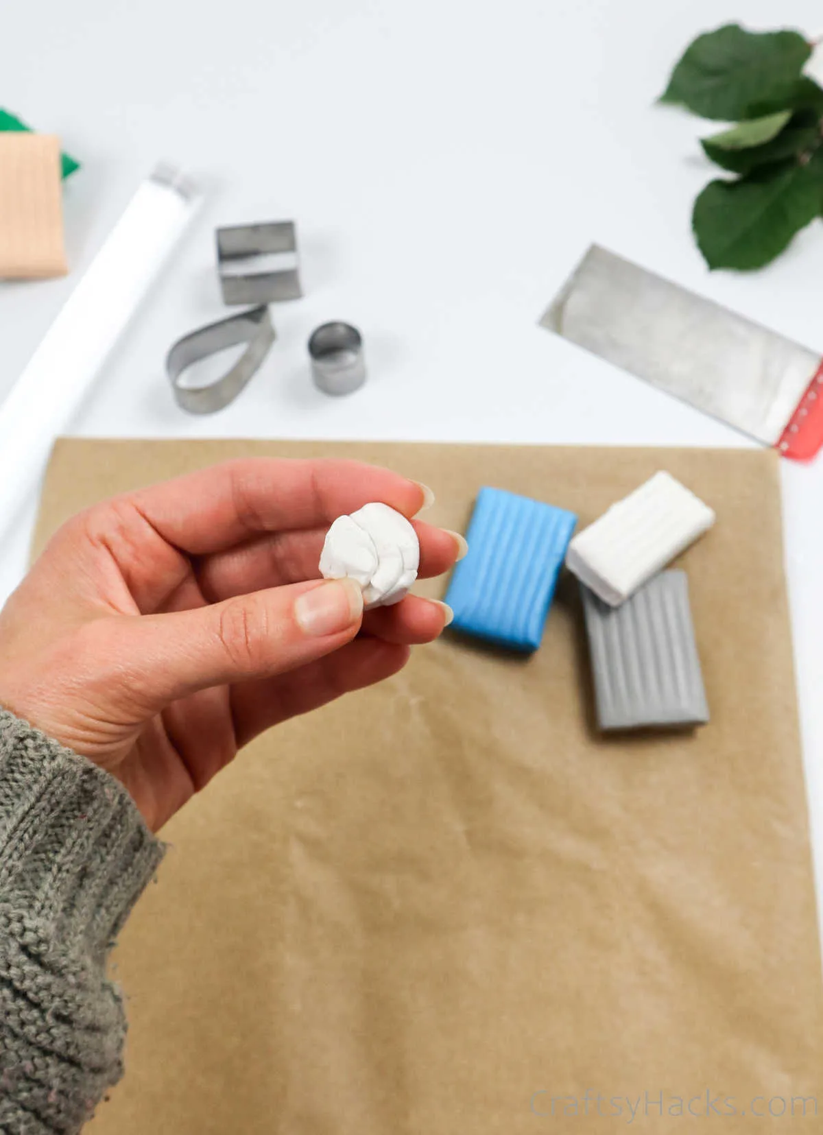 rolling ball of white clay