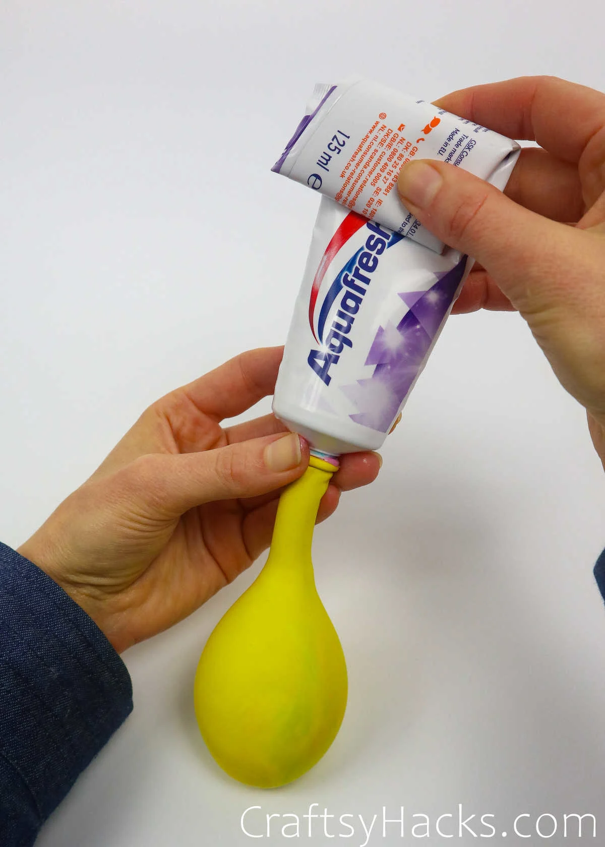 putting toothpaste in balloon
