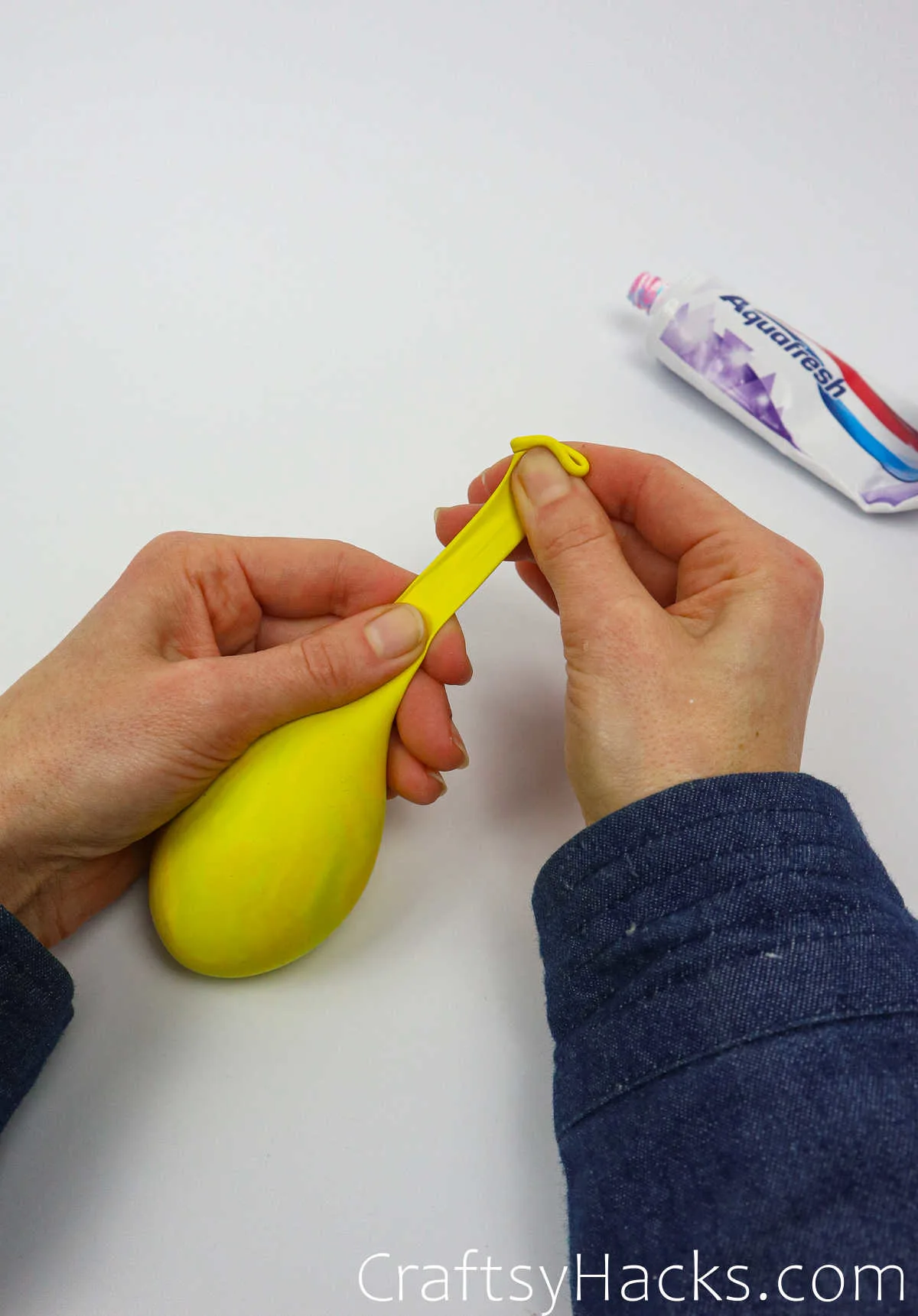 holding balloon with toothpaste