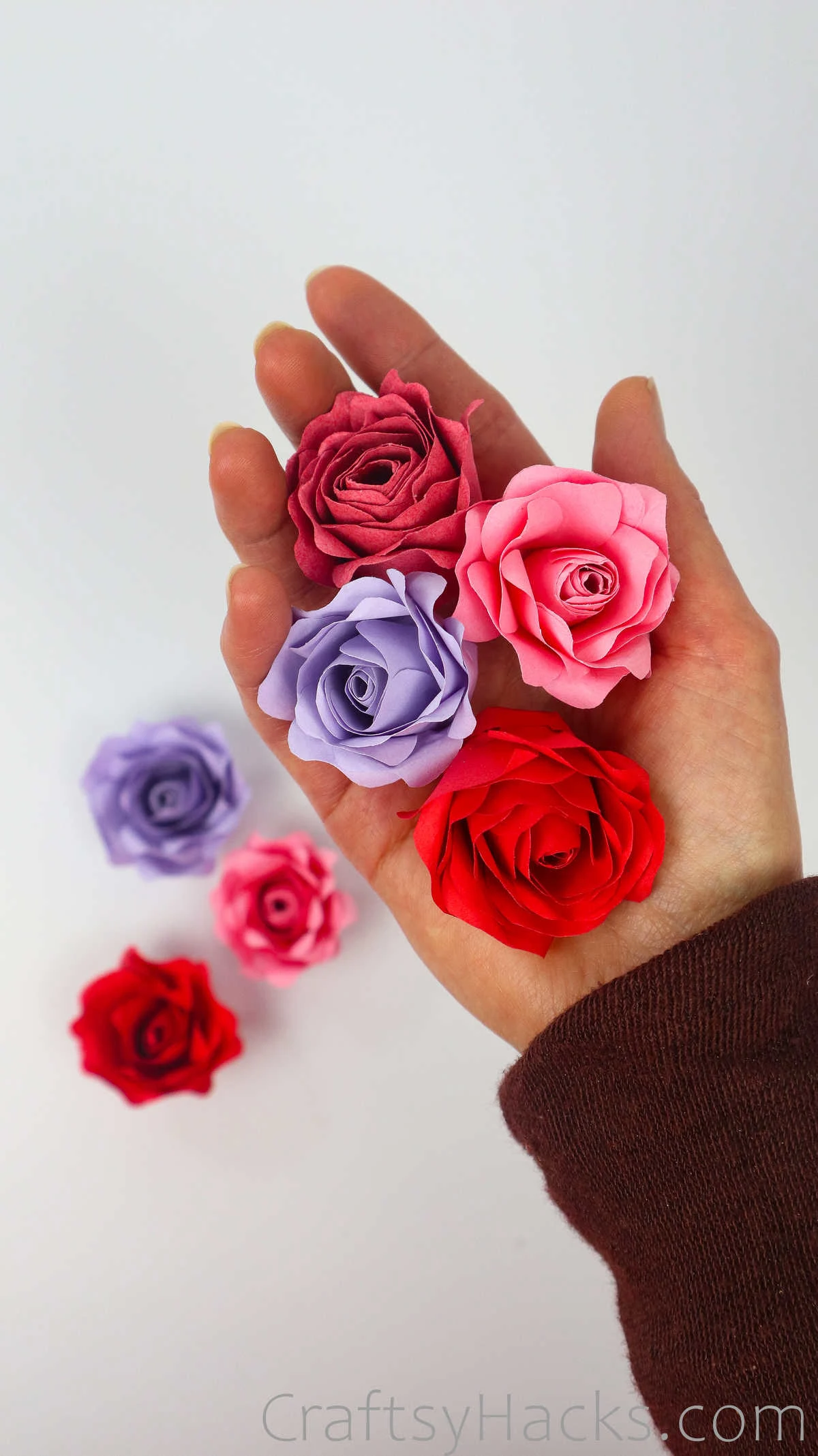 holding paper roses