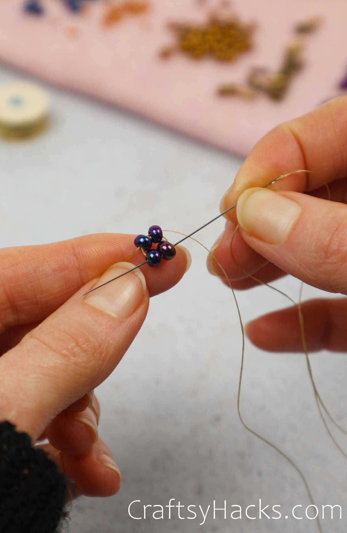 looping the needle through the beads