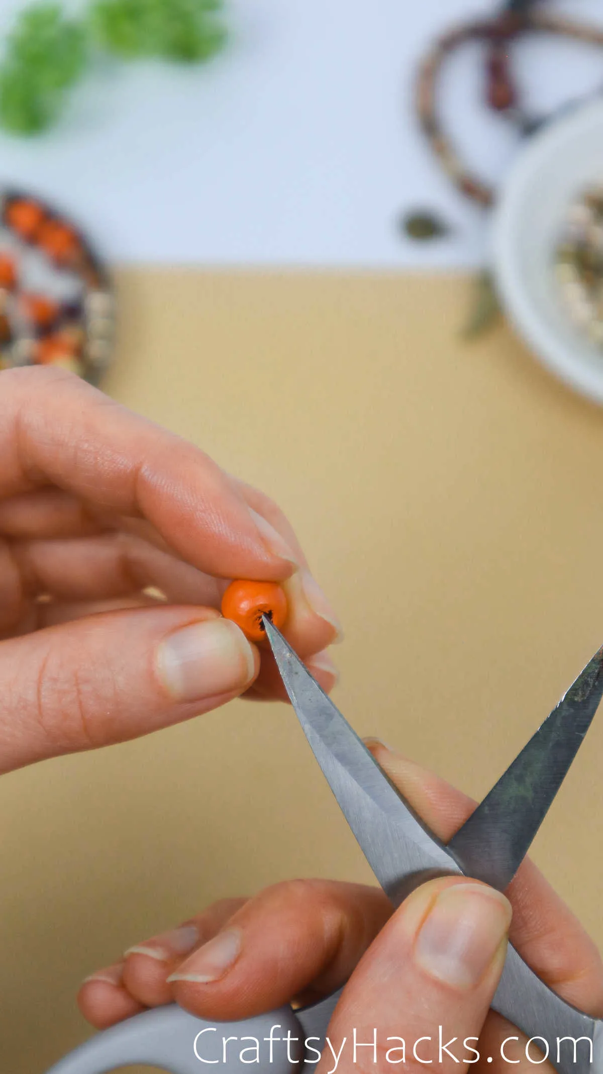 widen hole in beads with scissors
