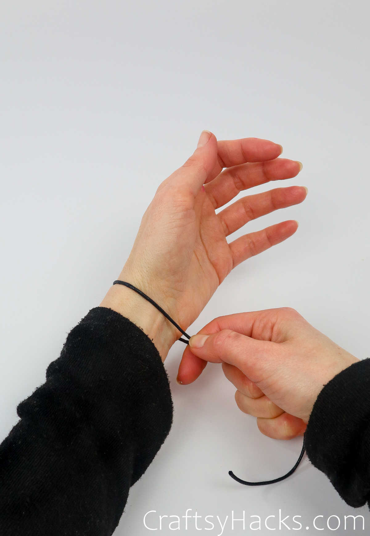 wrap piece of string around wrist to measure length