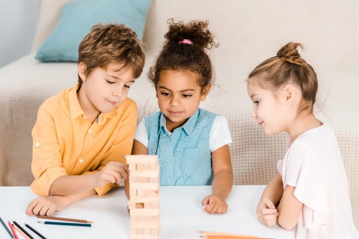 kids playing tallest tower with blocks