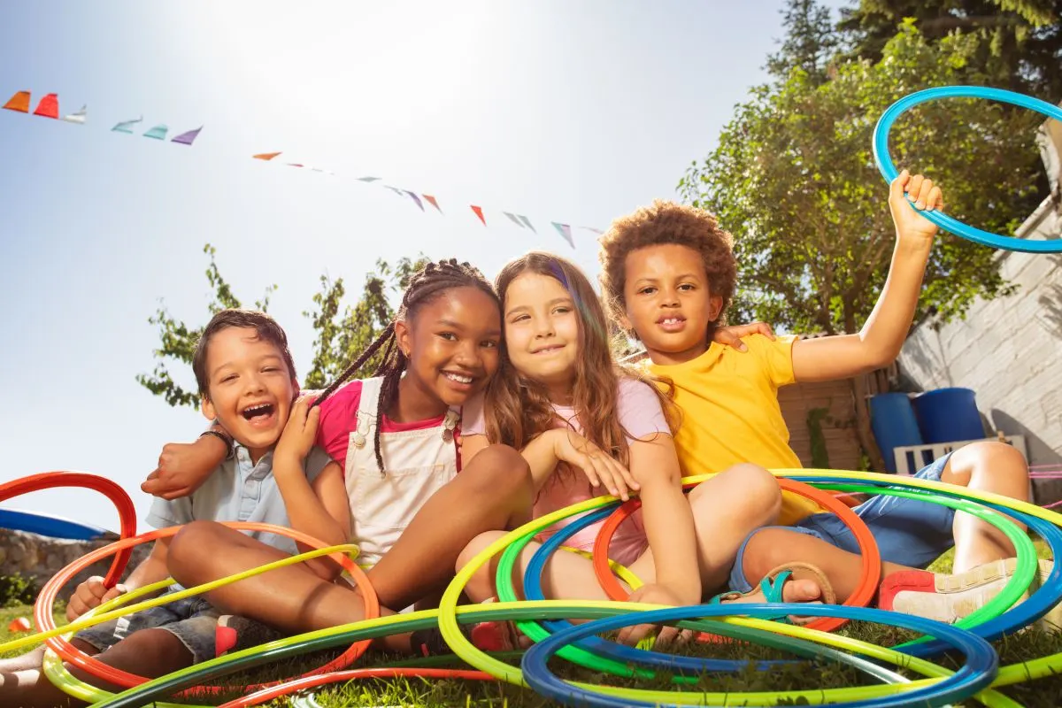 kids playing hula hoop pass