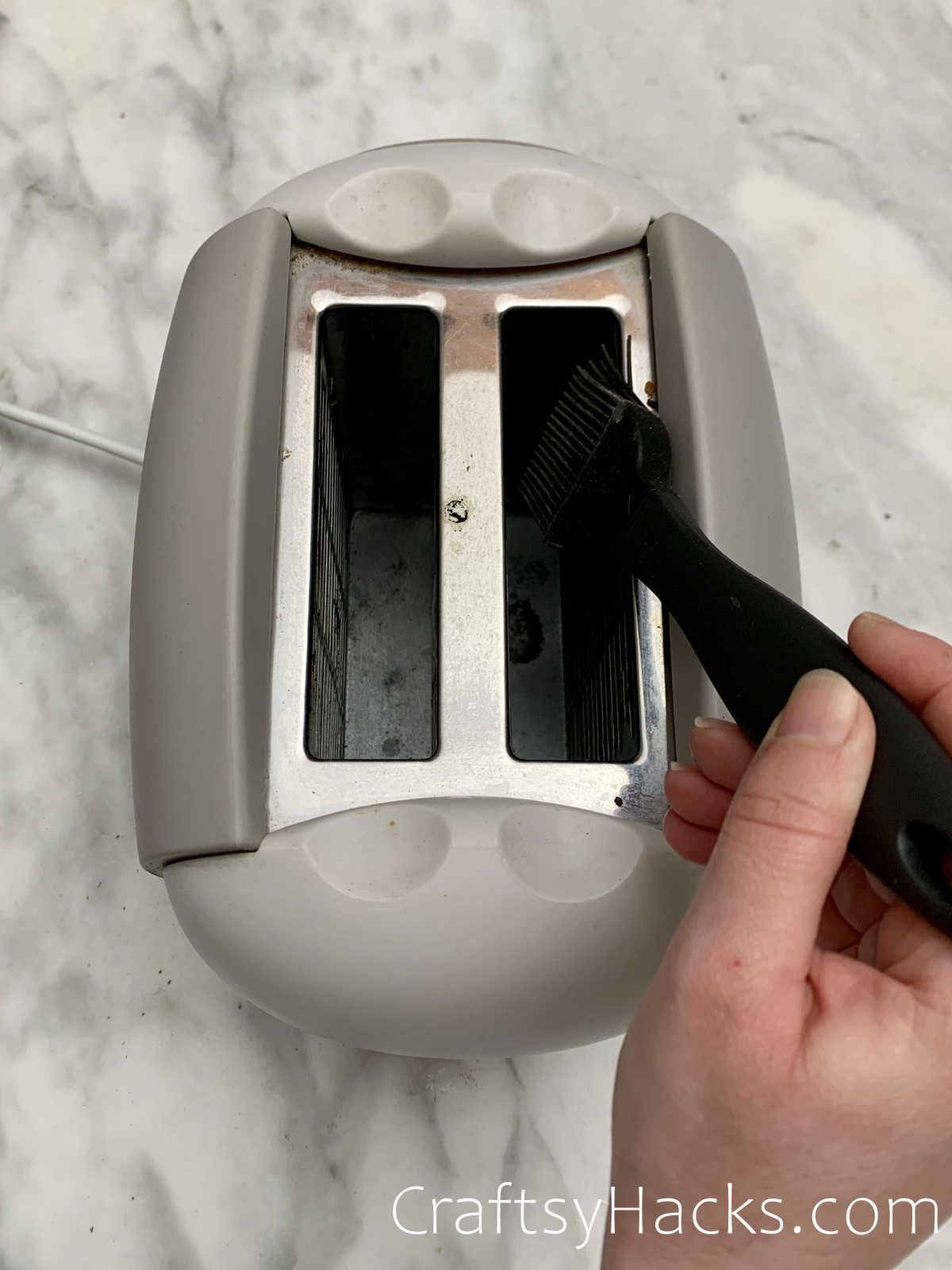 clean toaster with a pastry brush