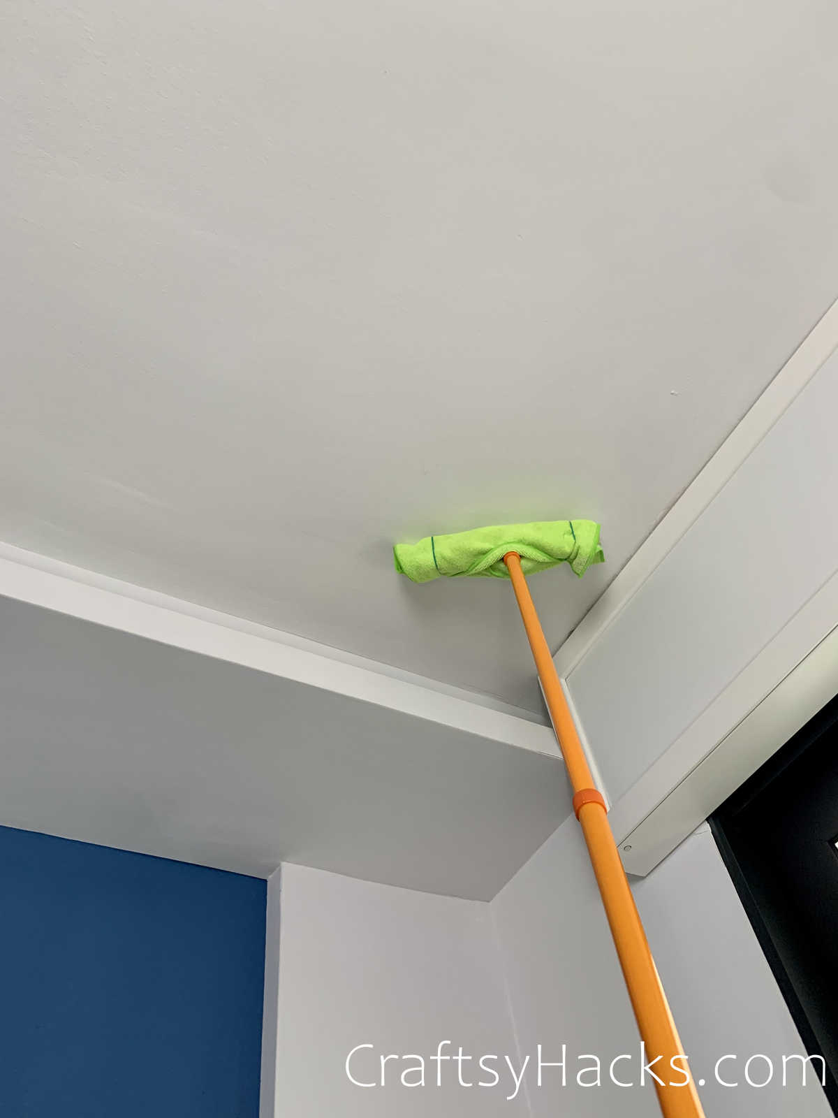 dust ceilings with a long handled duster
