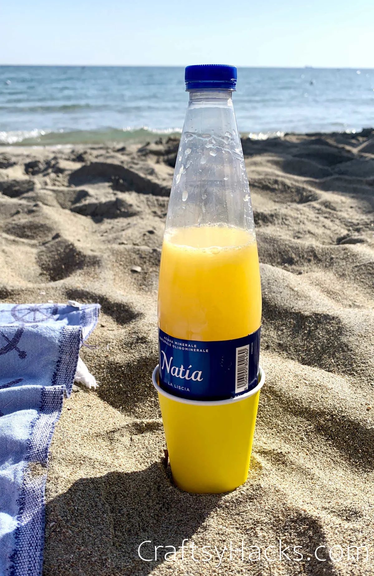 use paper cups to prevent sand from sticking to a bottle