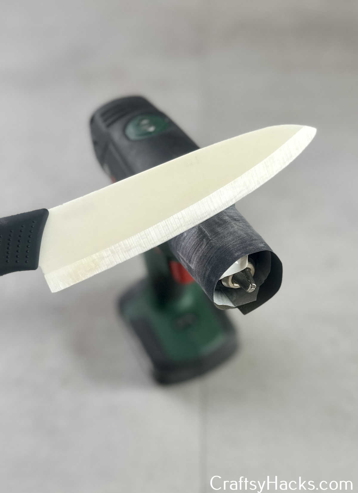 stick sandpaper around drill to sharpen knife