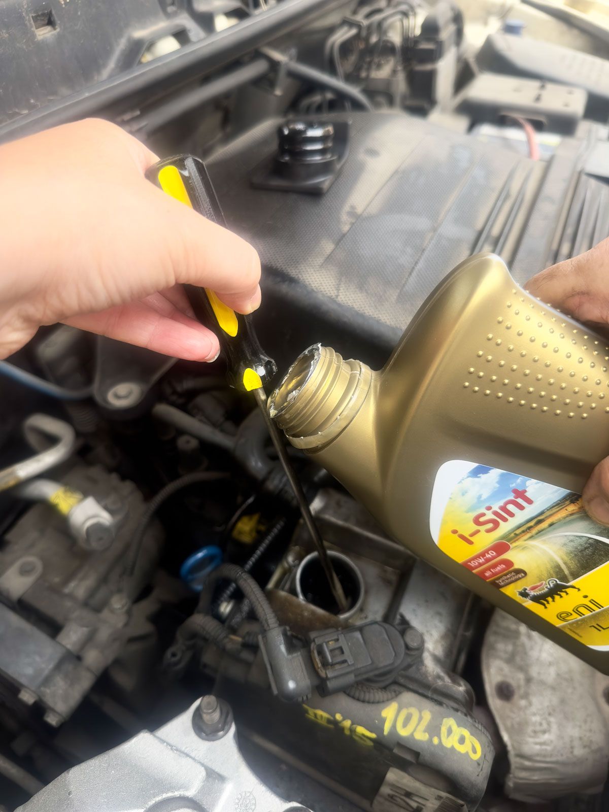 Use a Screw Driver to Pour Out the Oil