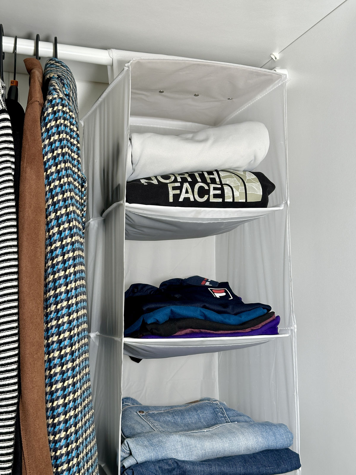 Use a Hanging Organizer to Store Clothes Vertically