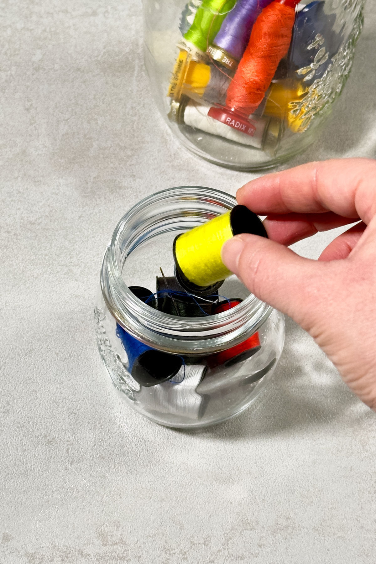 Use Glass Jars to Store Sewing Spools
