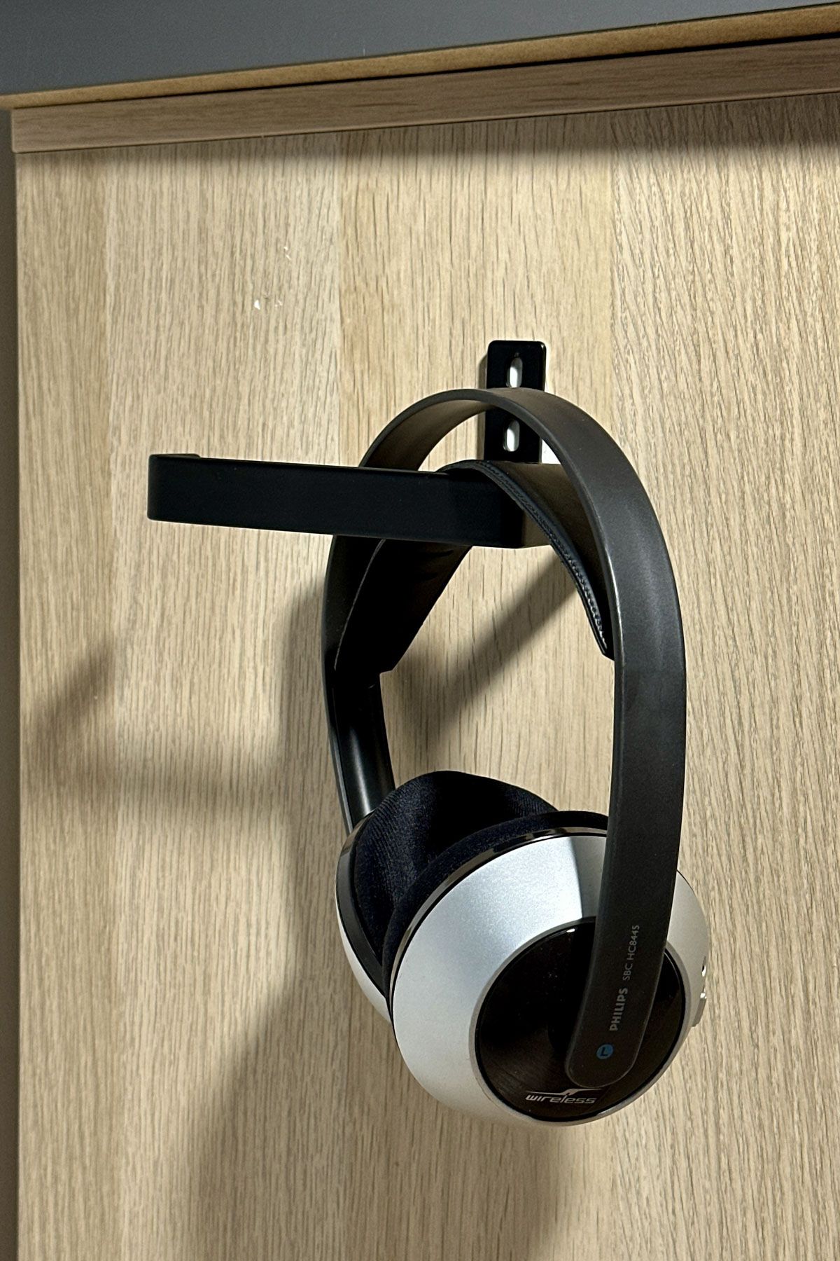 Use A Toilet Paper Roll Holder To Hang Your Headphones By The Desk