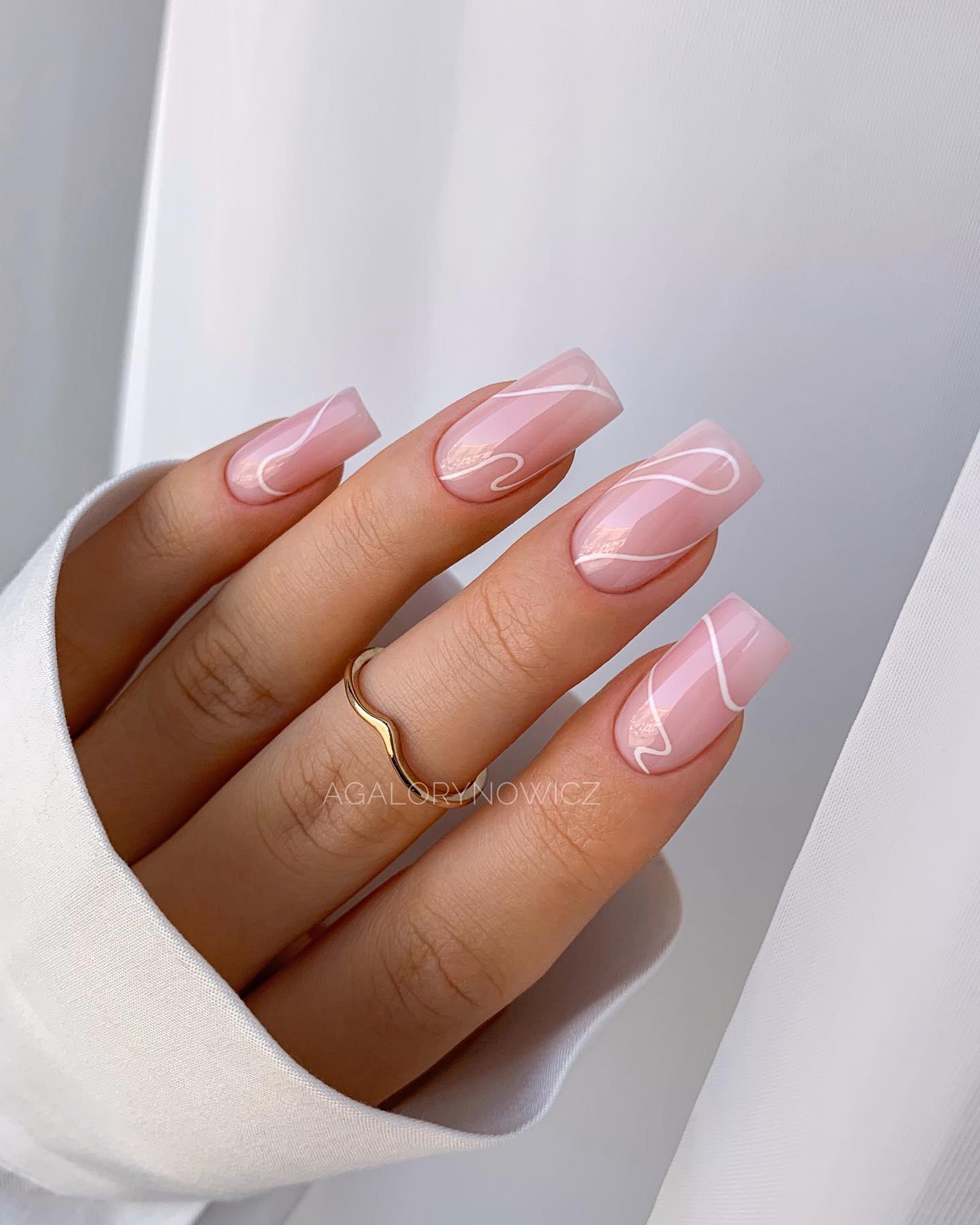 2. Pink Nails with White Swirls
