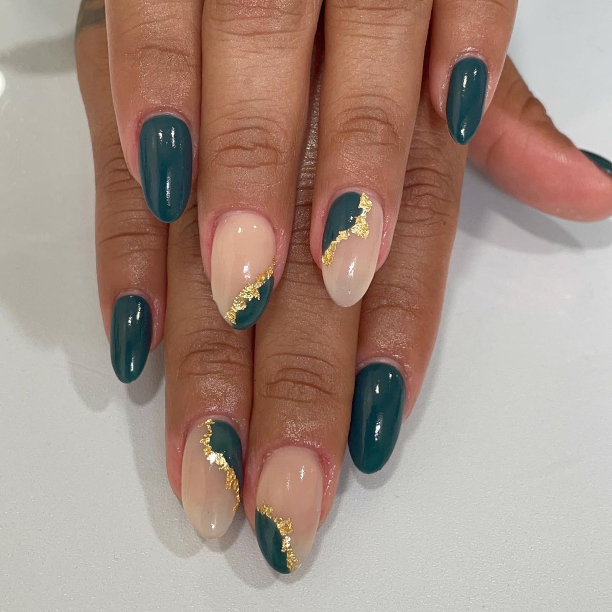 41. Classy Black, Nude, and Gold Manicure