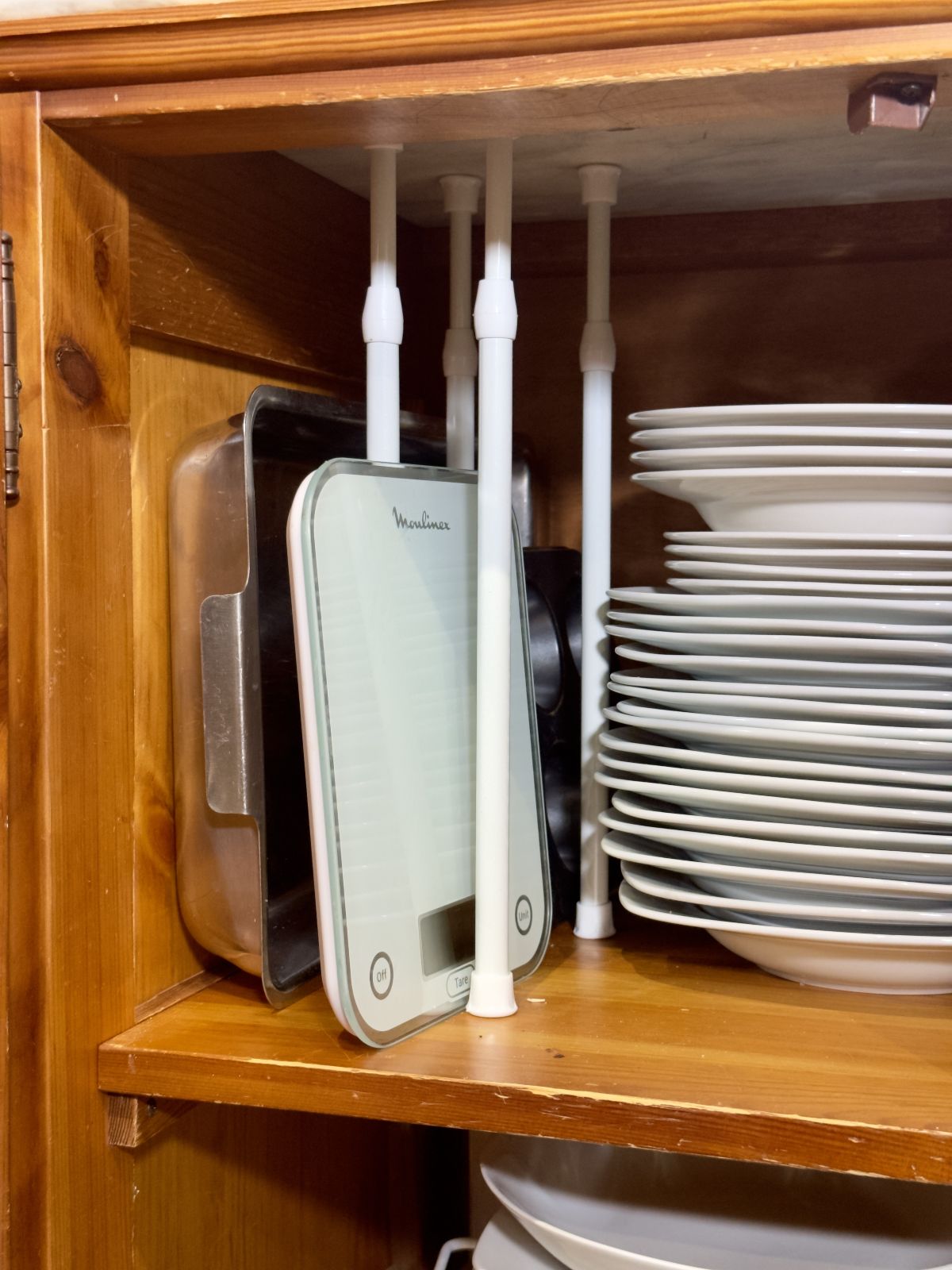 17. Organize Baking Sheets with Tension Rods